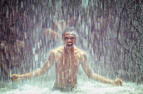 Ashwagandha Benefits, man sitting under a waterfall