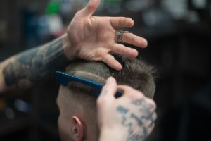 Testosterone and Hair Growth Understanding the Link, a barber cutting a mans hair