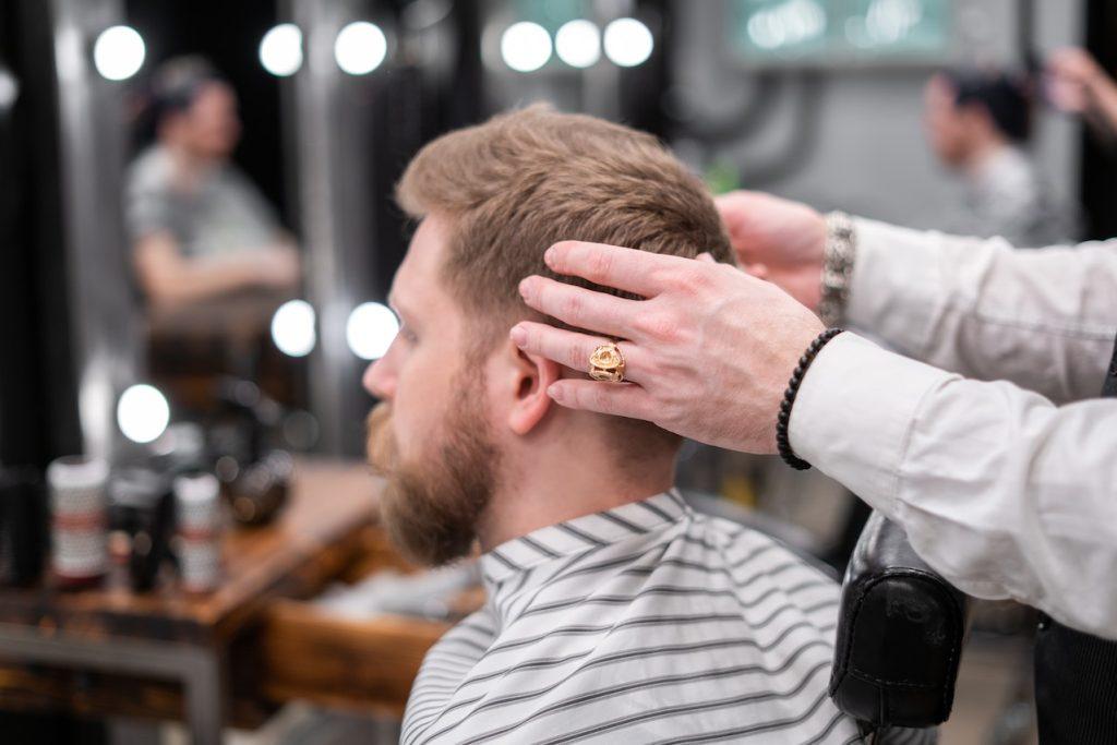 Testosterone and Hair Regrowth The Science Behind It and More, a man having a haircut